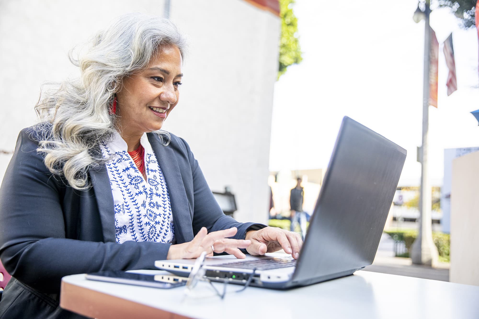 Woman smiling as she works on laptop