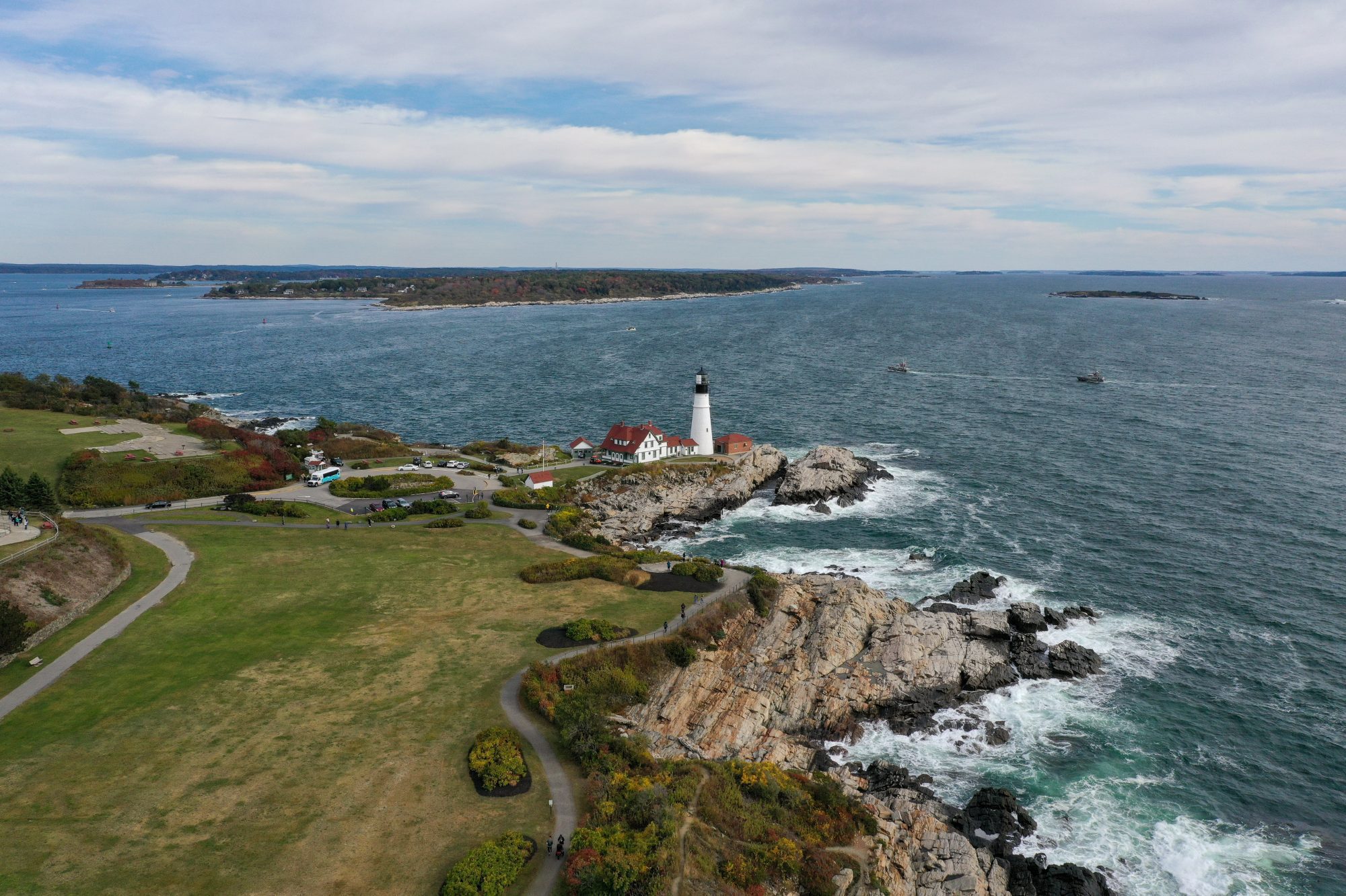 Aerial of New England coast line with lighthouse.